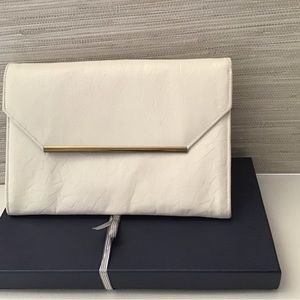 White patent leather chain link clutch.